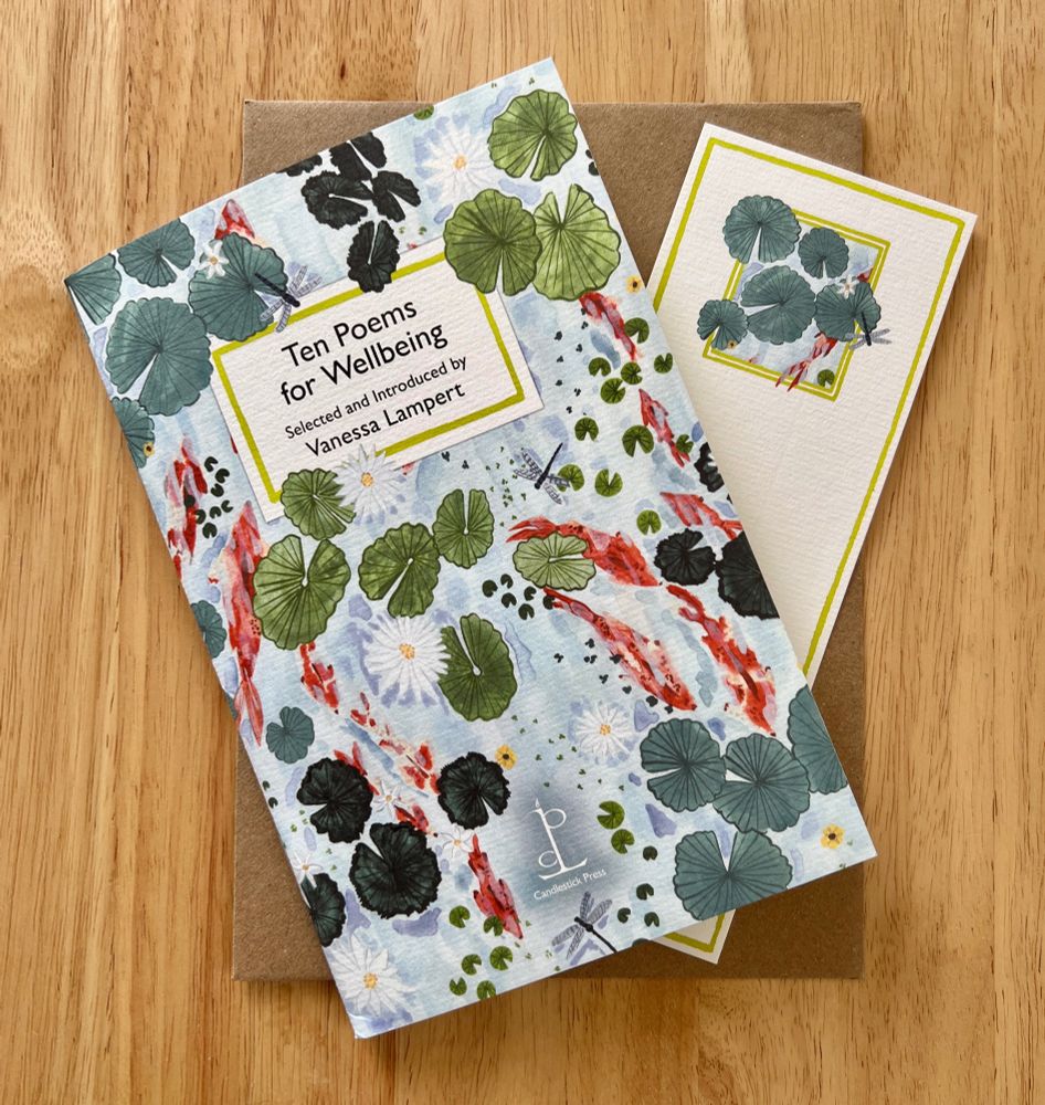 Photo from above of 'Ten Poems for Wellbeing' selected and introduced by Vanessa Lampert and published by Candlestick Press. Here is a matching bookmark and brown envelope too, on a wooden table surface. The cover is illustrated with a watercolour painting looking down towards the surface of a pond with orange/red fish, lily pads and flowers and dragonflies.