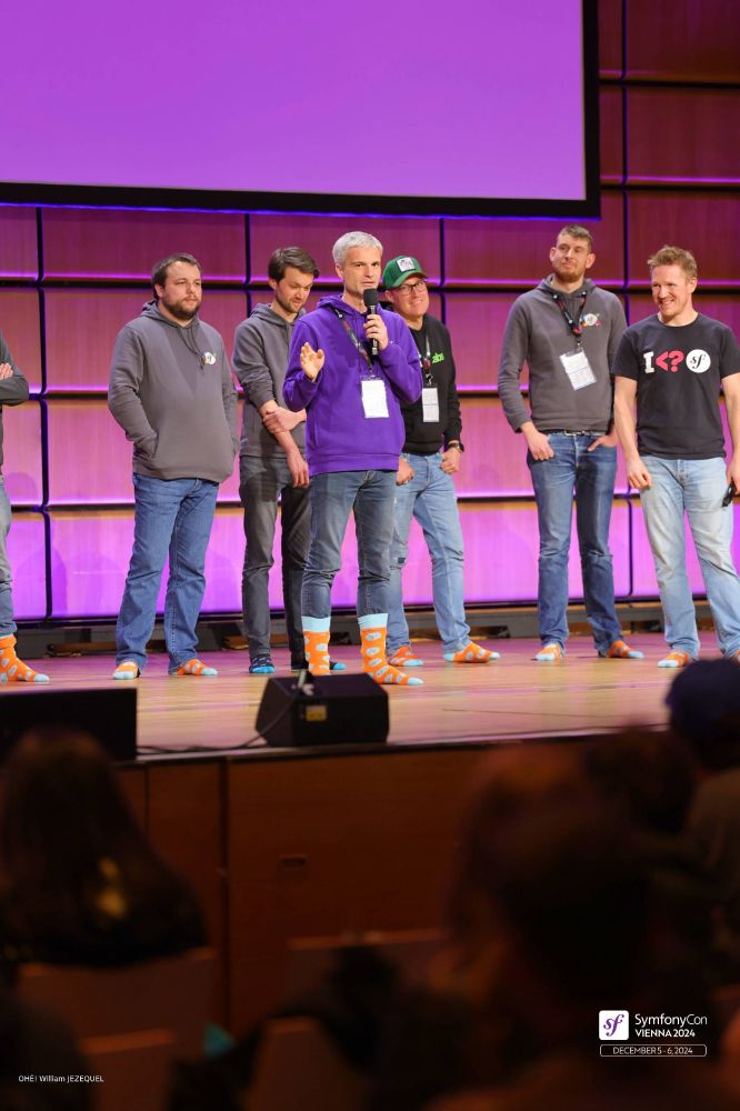 Photo of the SymfonyCon stage during the Core Team Q&A session, with all core team members walking on their socks.