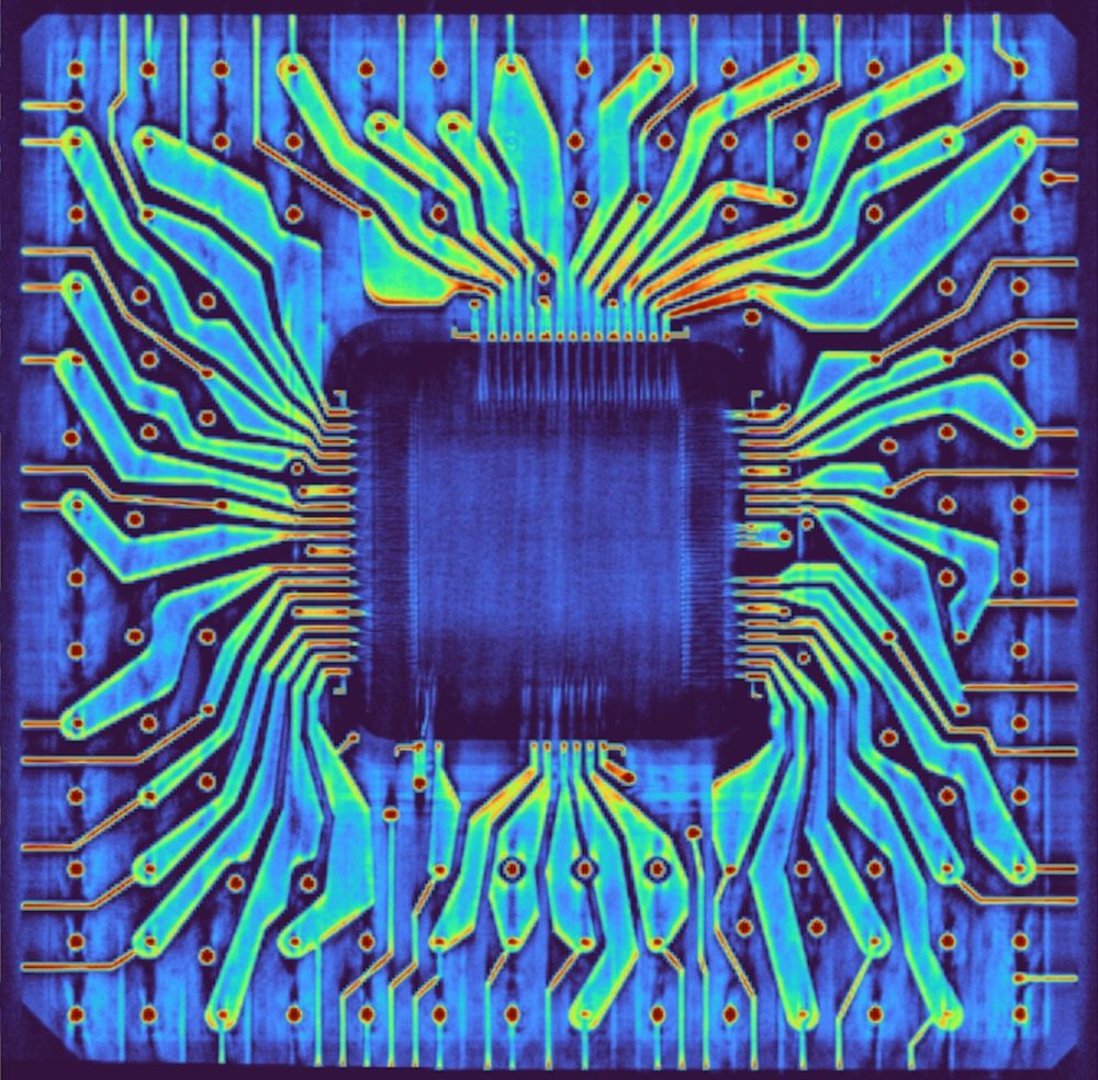 A colorful CT scan. There is a blue square in the center (the silicon die). Multicolored blobs reach out from the die, a bit like a sunburst in blues, greens, and yellows, or maybe like a tentacled sea creature. A grid of red dots over the image corresponds to the pins. Thin reddish-orange lines reach out to the edges of the ceramic package. The ceramic package itself is visible as a blue square background. The four corners of the package are clipped, three very slightly clipped and one clipped a bit more.