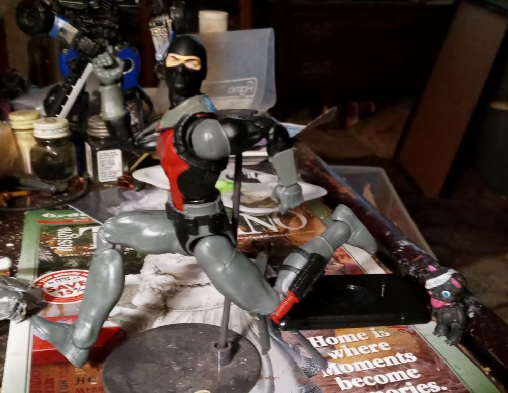 Cobra eel cartoon-style running away from a small teddy bear with a bandaged eye