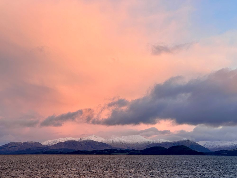 Sunrise over snowcapped mountains.  As seen on the ferry from Oban to Mull 
