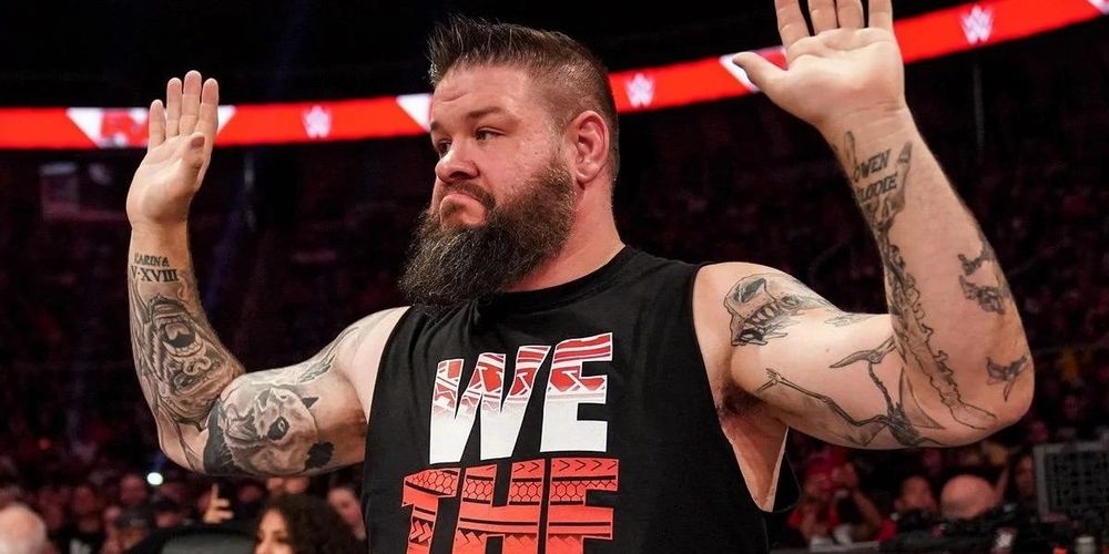 Kevin Owens with his hands up