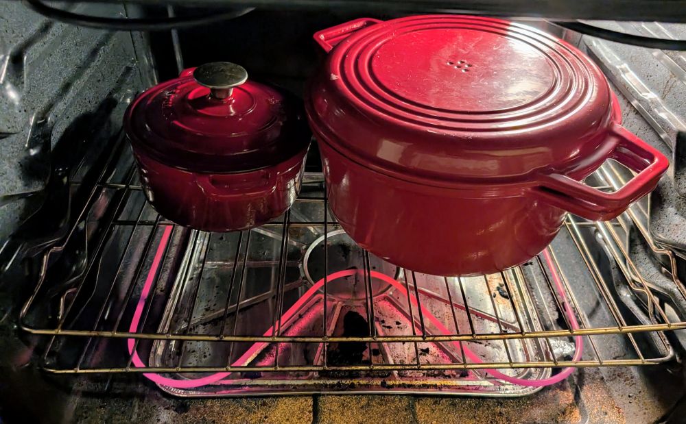 Big and little red pots in oven