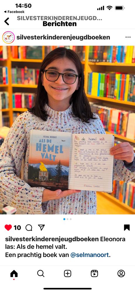 Girl about 13 years is holding my book (When heaven comes down) en her handwritten review on it. 