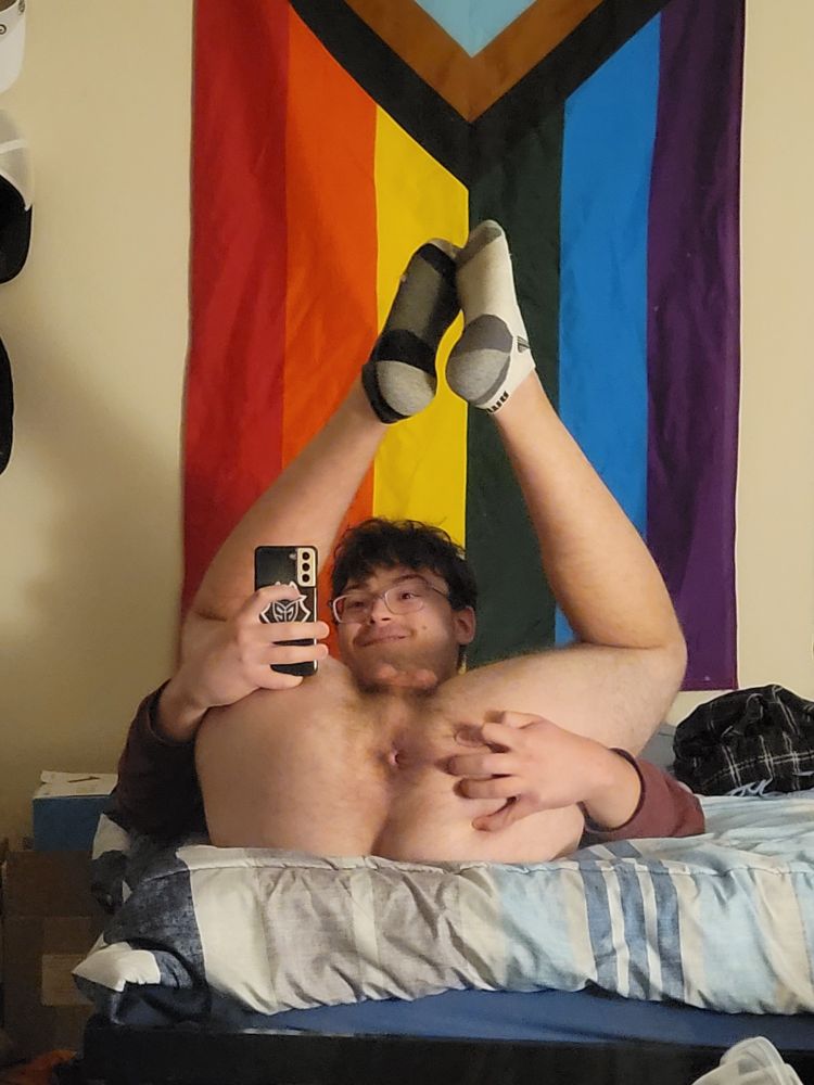 Laying on my back, feet in the air exposing my hole.