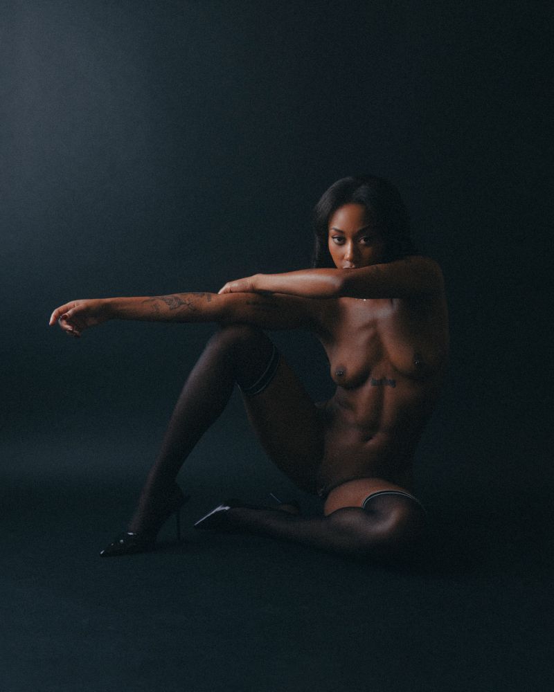 shiksa poses nude in interesting shape with her arms extended, her legs partially bent and spread open