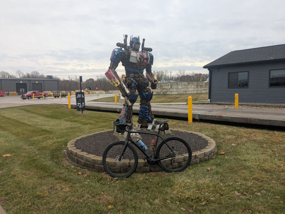 Bike leaning against a transformer statue