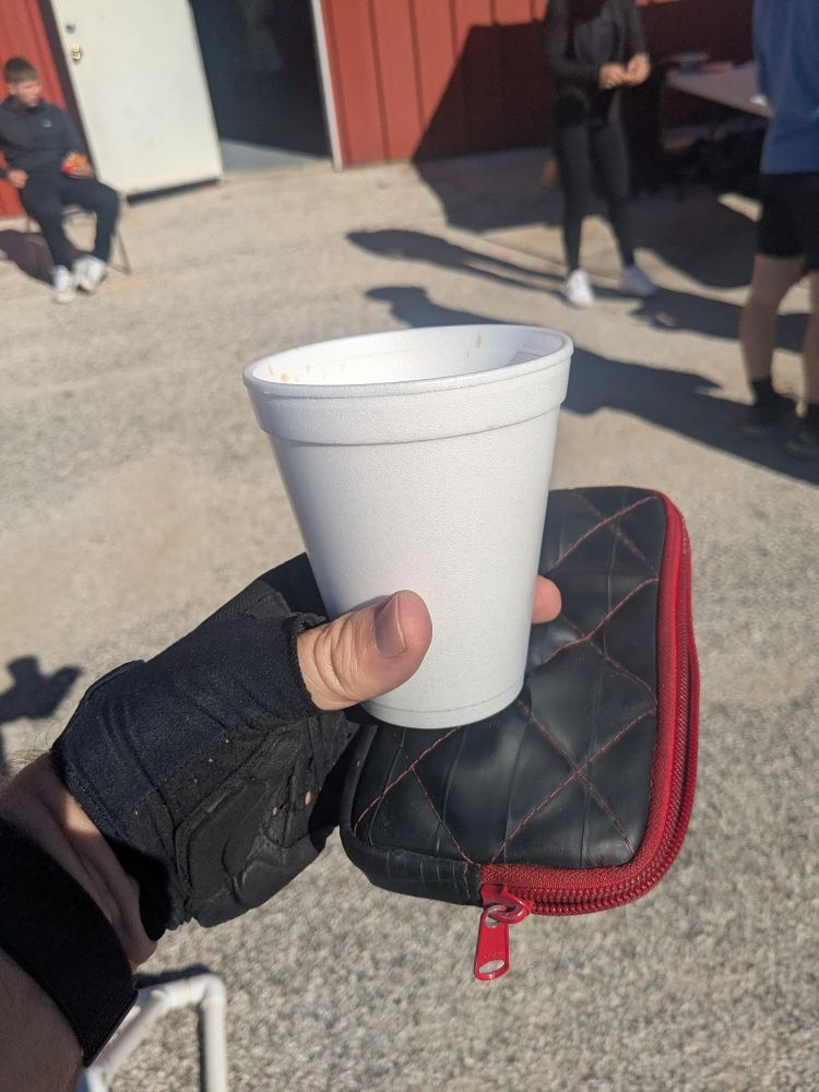 A picture of a Styrofoam cup with coffee at a cycling SAG stop