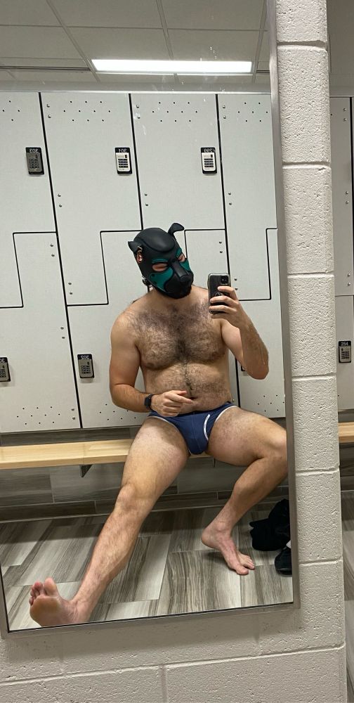 Me in the gym locker room, pup hood on, briefs I’m working on for a pup