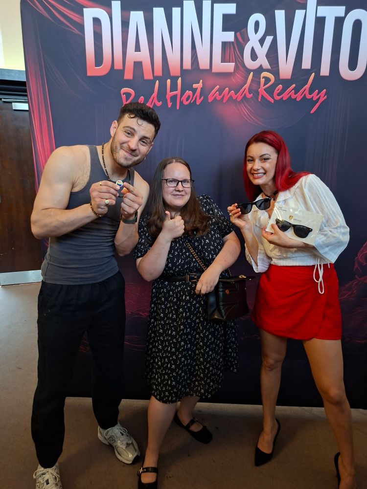 Vito holds a pride badge and Dianne holds up some LUFC sunglasses!