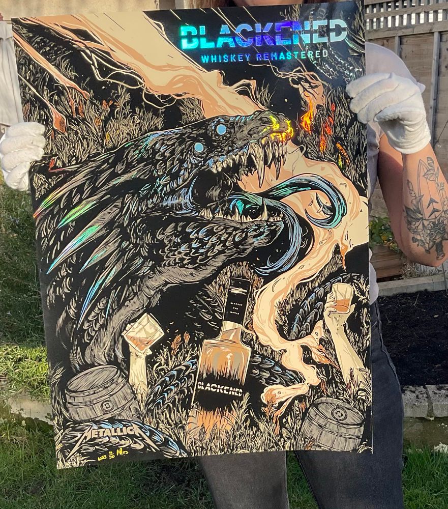 Me holding a Blackened Whiskey poster 