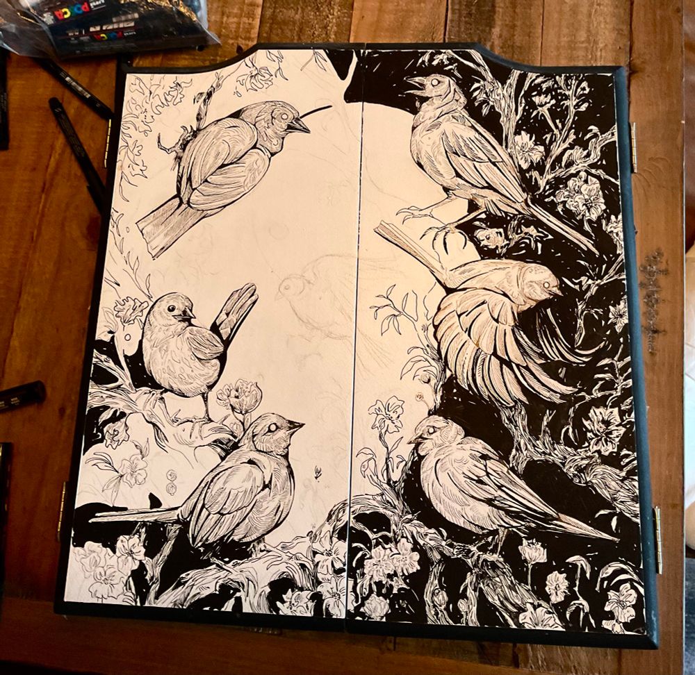 Work in progress of a dartboard cover. Inking birds and foliage 