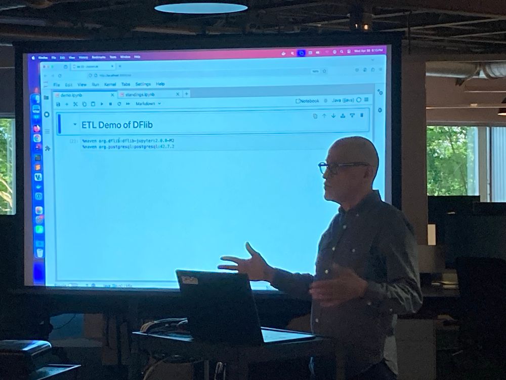 Andrus Adamchik presenting DFLib in a Jupyter notebook in front of a screen 