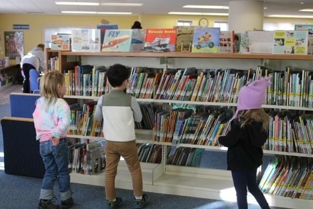 Children browsing picture books at the library. 