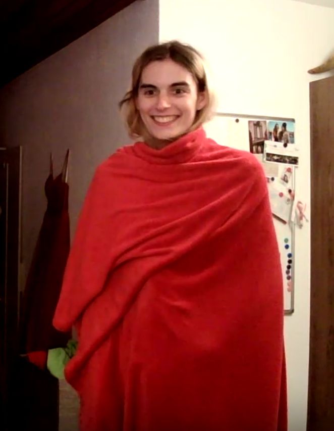 viktoria wrapped in a red blanket extremely grinning