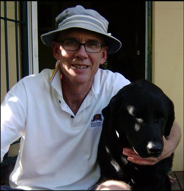 A photo of me on the front veranda with my black lab Harry, looking mopey for the camera.