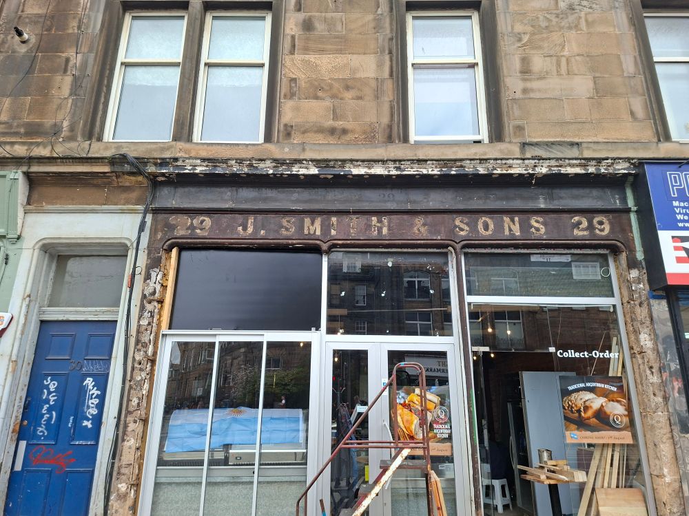 A takeaway shop  on Leith Walk reveals its ghost sign. 