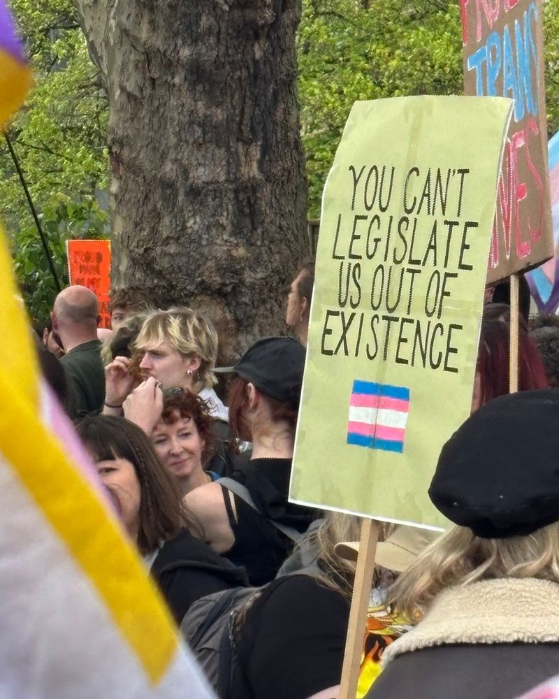 Someone holding a sign saying "you can't legislate us out of existence."