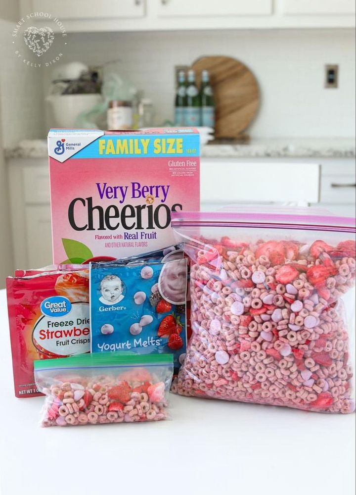 sombodies home made “baby trail mix” of berry cheerios, gerber yogurt melts, and freeze dried strawberries in a bag
