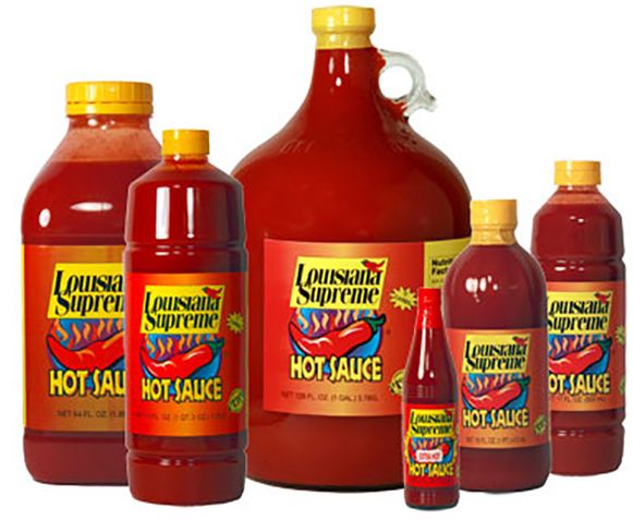 stock photo of the brand Louisiana Supreme in their variety of sizes for their hot sauce including a huge jug of it