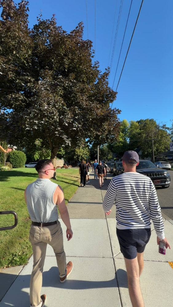 Men walking down sidewalk
