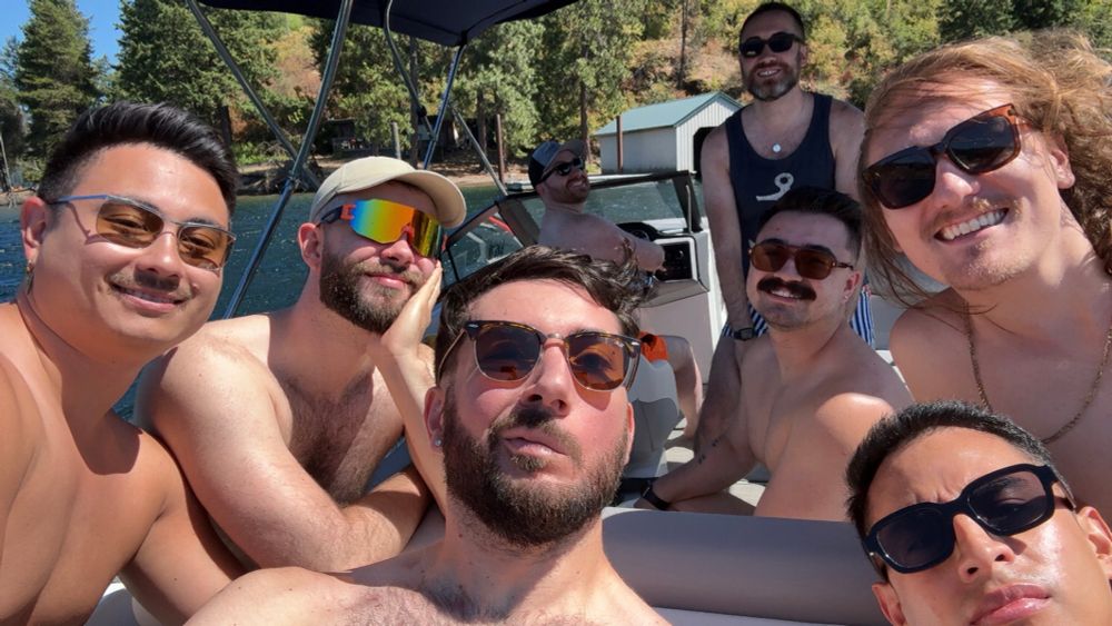 Young men in sunglasses on a boat