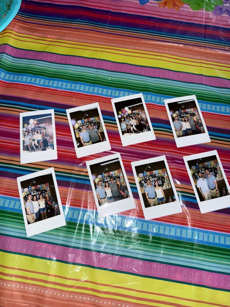 Polaroid photos on a colorful tablecloth 