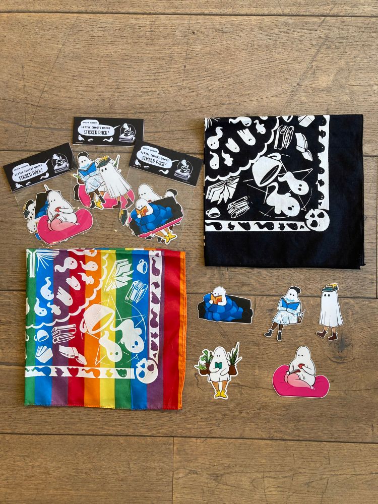 Little ghosts bandanas (rainbow & black with white print), the little ghosts sticker pack, and the reading ghost stickers all splayed out. 5 stickers, one is a ghost curled up with a coffee on a pink poof, a ghost in yellow rain boots reading while surrounded by plants, a little ghost balancing three books on its head, a ghost in a toque reading a tattoo book while covered in little blue tattoos, and a ghost curled up reading on a couch under a blue quilt.