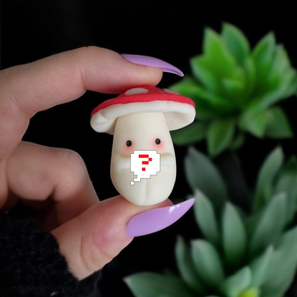 Hand holding a cute little glow in the dark mushroom with a red had, holding a mystery token. With little black eyes and rosy cheeks. On a black background with plants. 