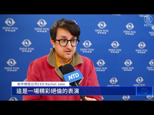 Brace Belden being interviewed by Shen Yun; the caption labels him "Rachel Jake"