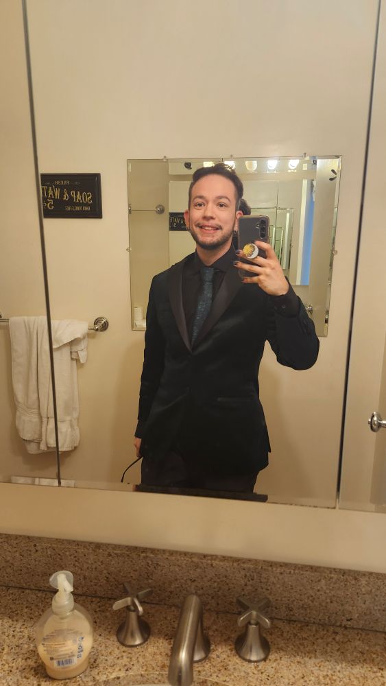 Rue in the same outfit from the previous picture but without the glasses.