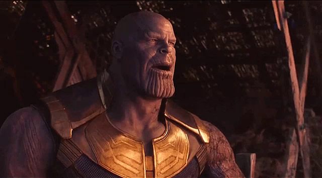 thanos from the movie avengers infinity war has a beard and a gold vest