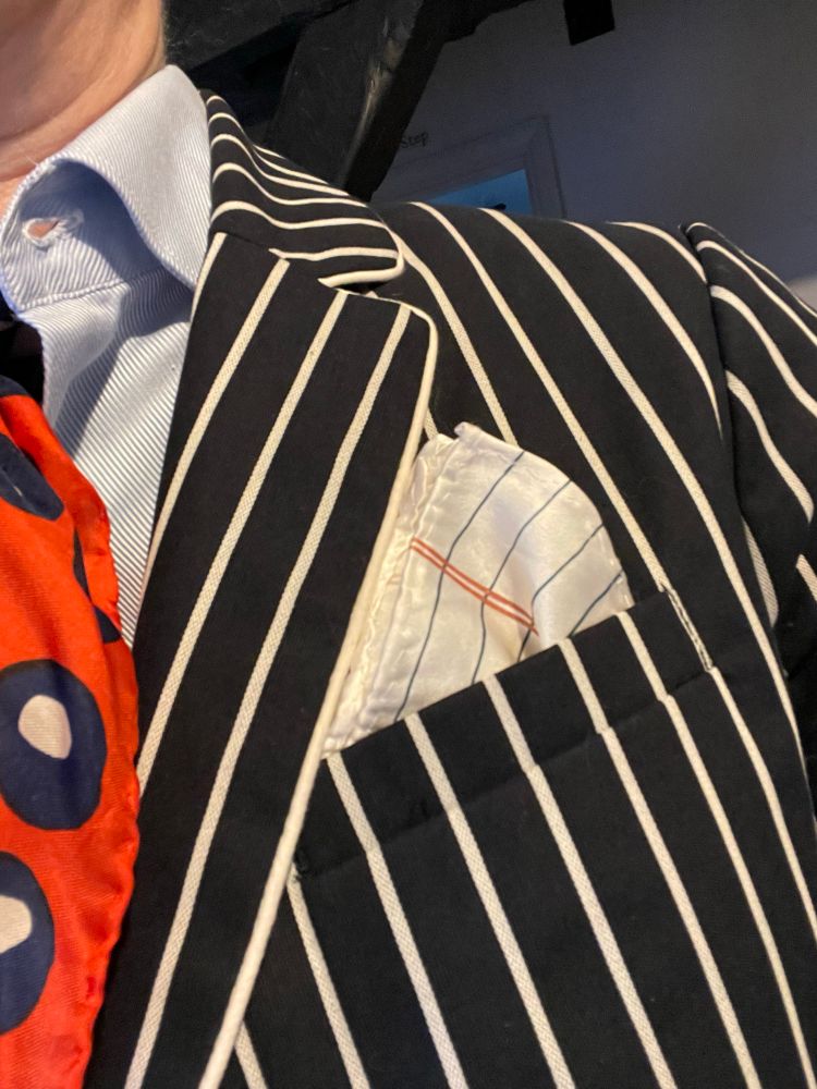 We know it’s about the details. A silk pocket square printed like a piece of college ruled notebook paper in the pocket of a navy and white striped schoolboy blazer.