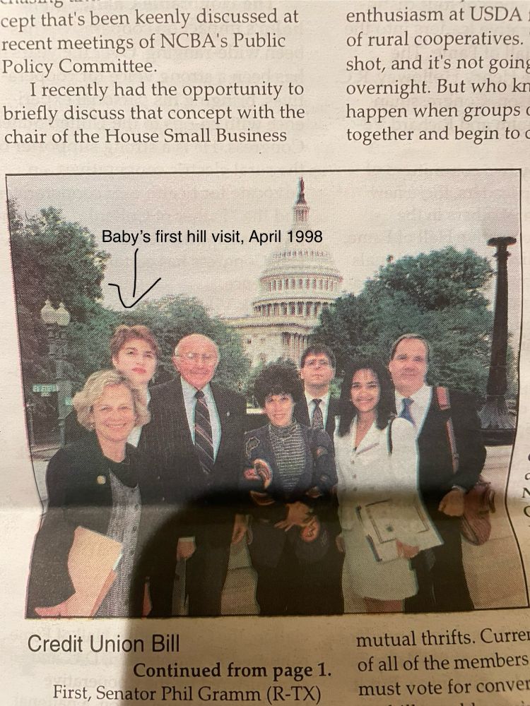 A photo of a newspaper clipping from 1998 of the same person at 20 as part of a delegation of people in front of the Capitol dome with the text “Baby’s first hill visit, April 1998” over their head.
