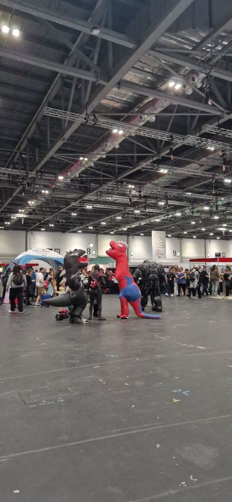 A picture of spiderman and vemon but as dinosaurs cosplayers 