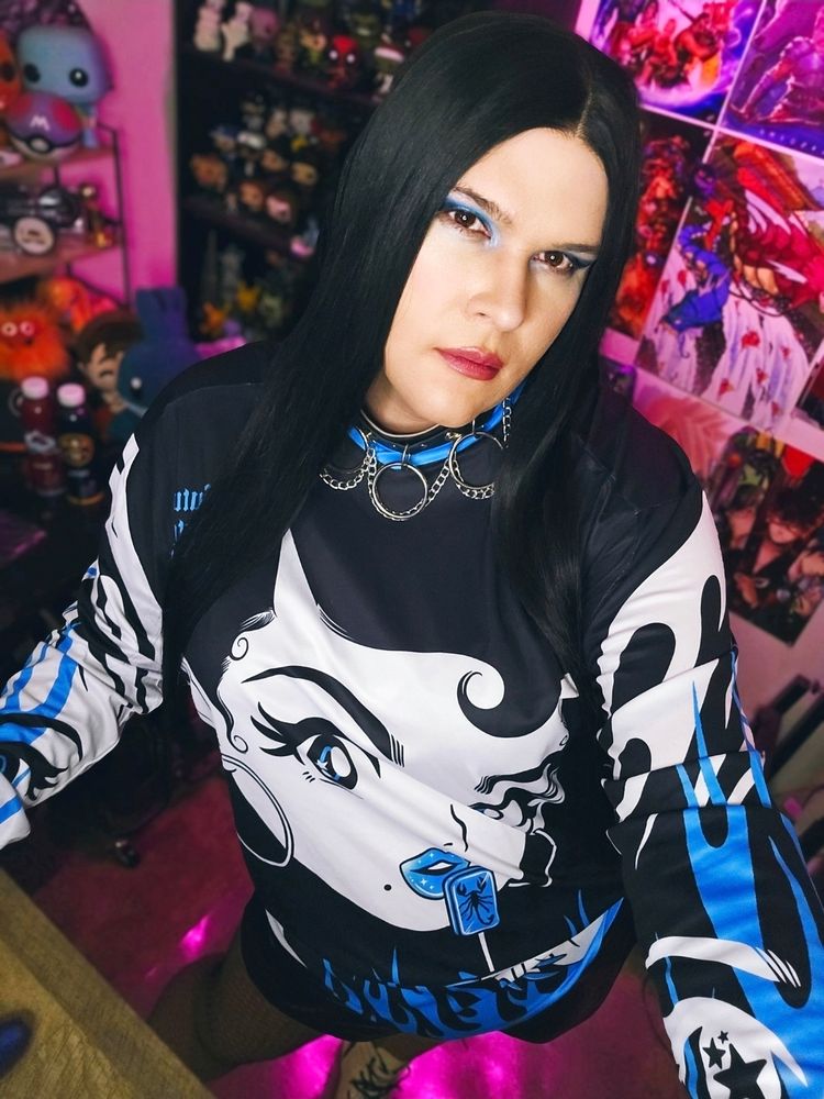 Eva standing in a black,white, and blue jersey