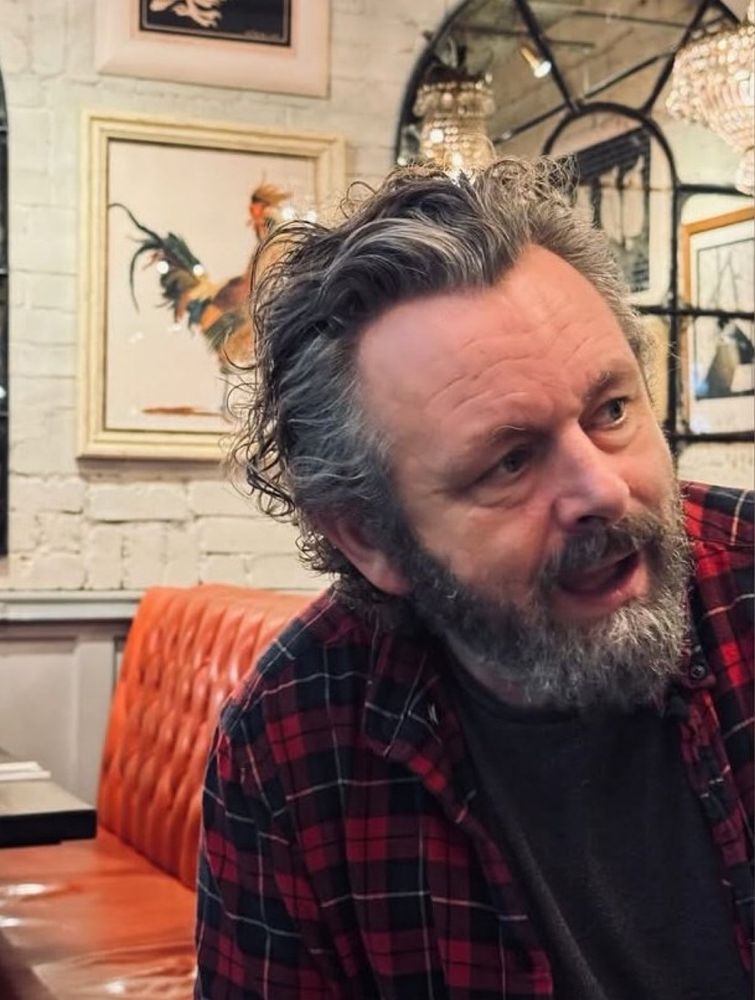 Michael in front of a rooster with his flannels on!