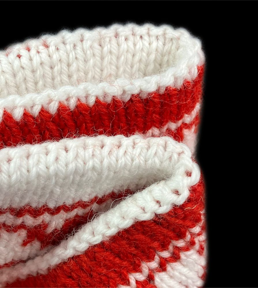 Close up of top and bottom edges of a red and white double knitting project