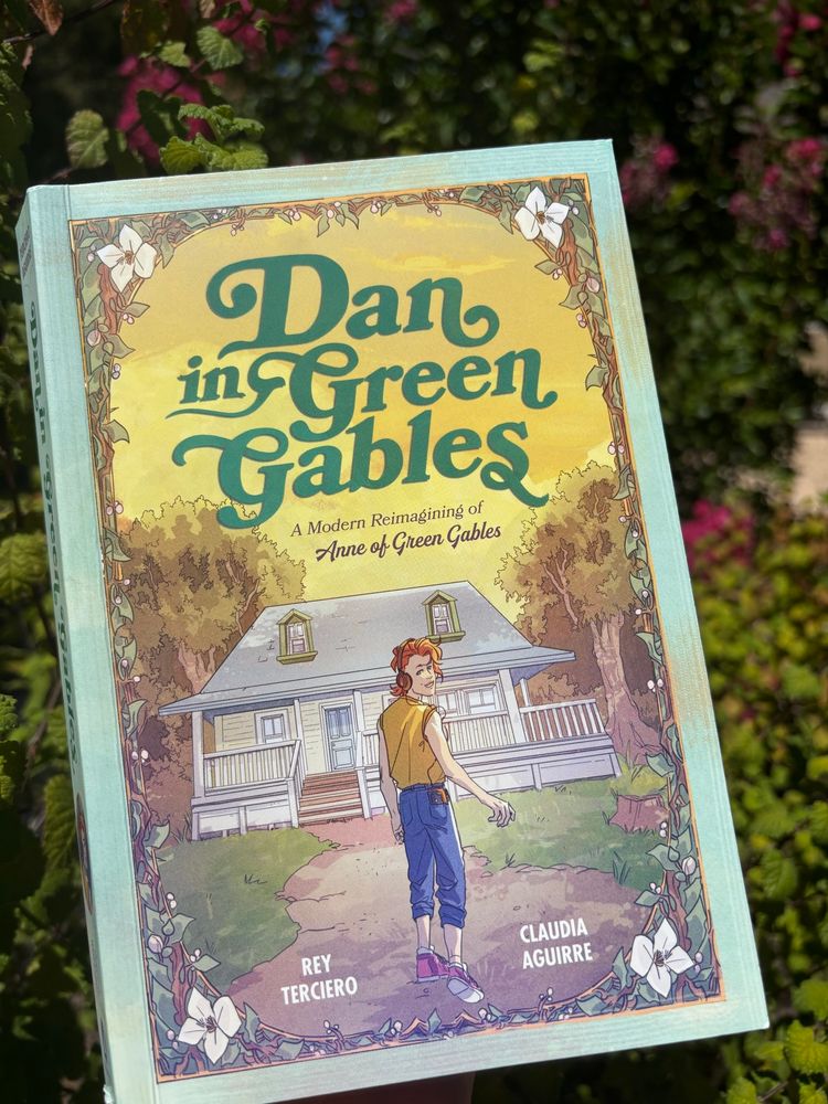 Book cover of Dan in Green Gables: A Modern Reimagining of Anne of Green Gables. There is a young man with red hair and headphones walking toward a house with a wraparound porch. He is looking over his shoulder at the reader.