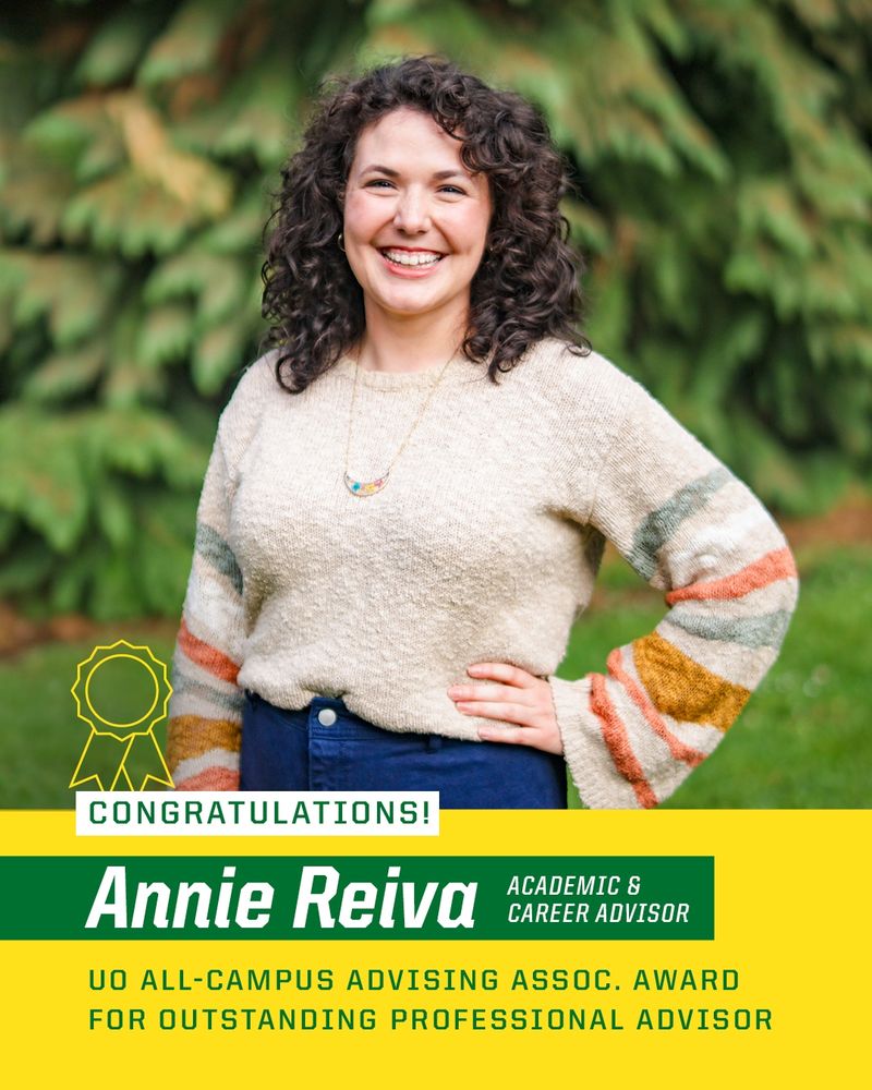 Congratulations to Annie Reiva for receiving the UO All-Campus Advising Assoc. Award for Outstanding Professional Advisor. Image features the award recipient standing outdoors with trees in the background, smiling, with hands on hips. They are wearing a multicolored sweater.