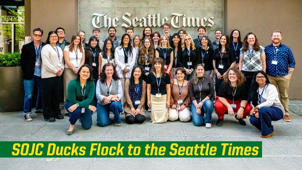 Group photo of journalism students in front of the Seattle Times building, with a banner reading "SOJC Ducks Flock to the Seattle Times.