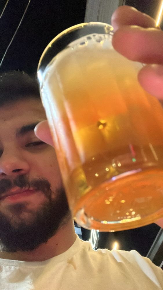 eu encostando um copo de cerveja na camera