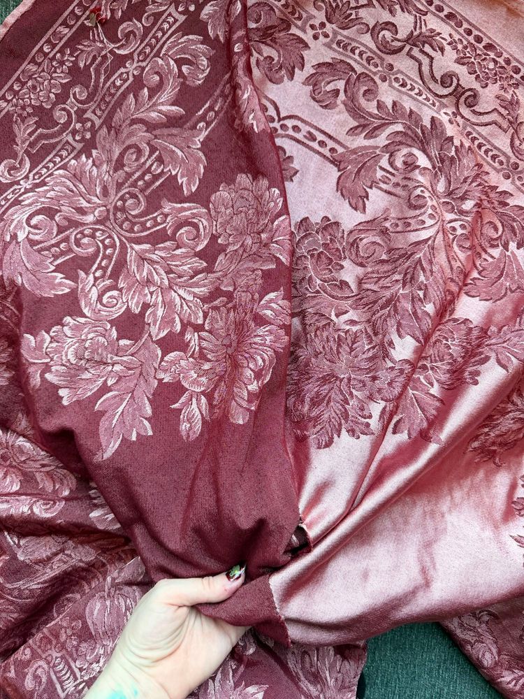 Both sides of a brocade bedsheet dyed to an interesting dark burgundy and shimmery light mauve. On one side, the brocade pattern is light on a dark background. On the reverse side, it came out dark on a light background. 