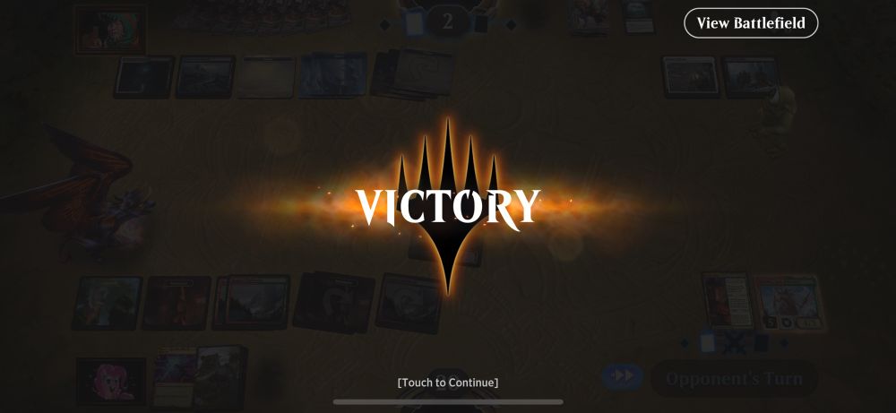 The word "victory" is center of a faded out screen with a played out Magic the Gathering Arena game. 