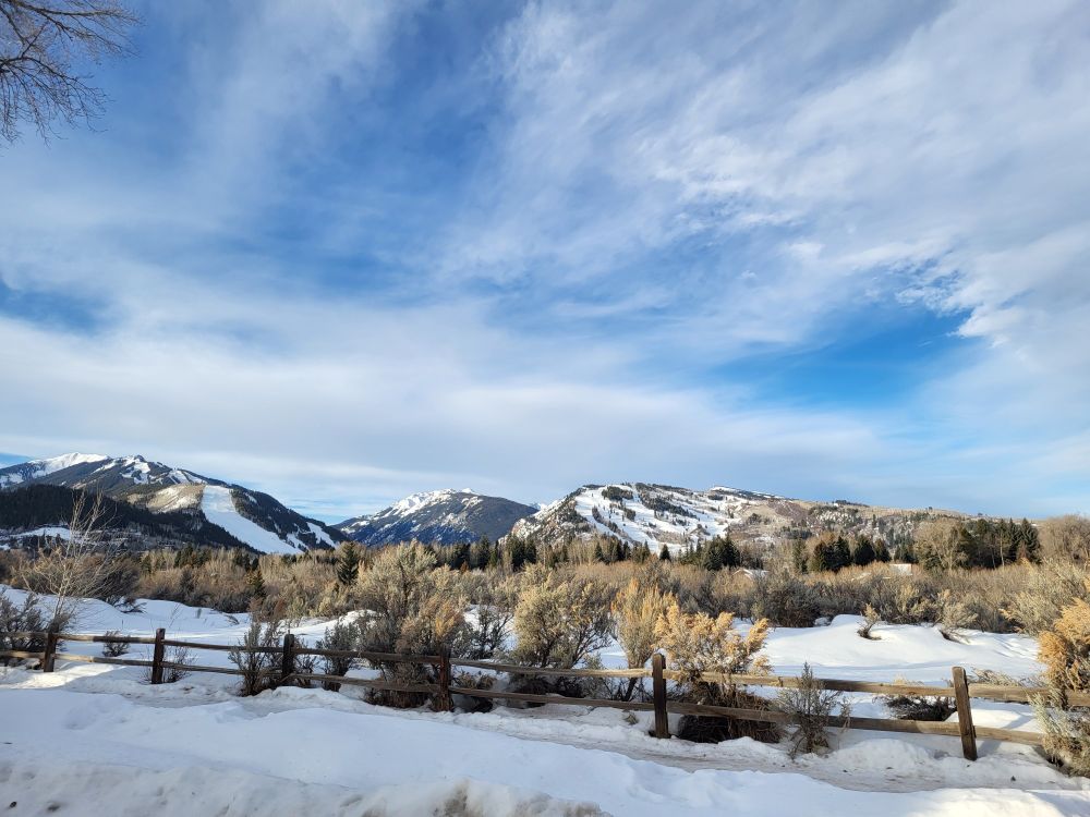 landscape scene of snowy mountains and dramatic sky