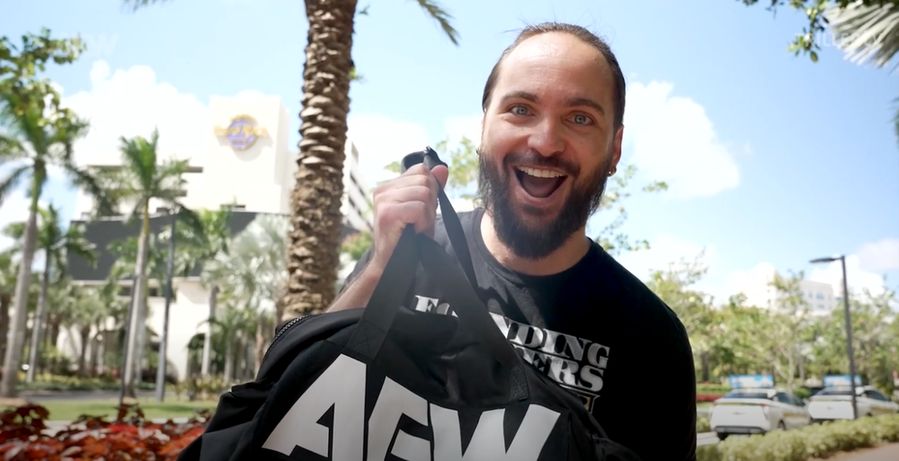 Nick Jackson holding up a big bag of cash outside a casino with a gleeful look on his little gremlin face