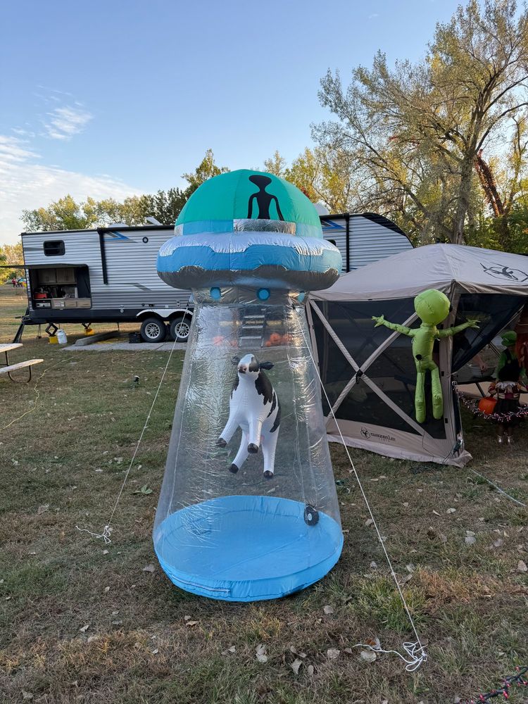 An inflatable Halloween decoration of a flying saucer levitating a cow but it all looks like a giant penis