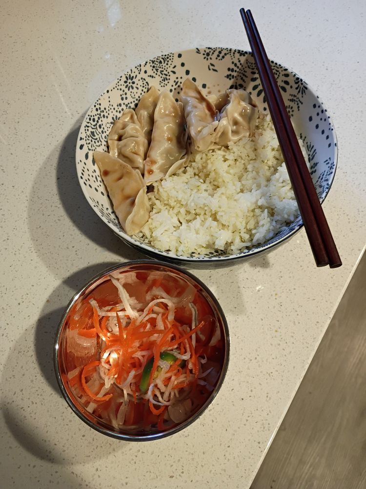 Veggie dumplings, rice, and pickled veggies.
