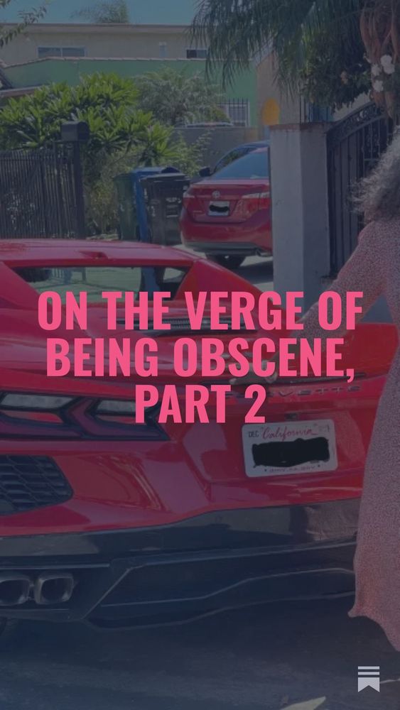 Pink text: On the verge of being obscene, part 2. The text is overlaid. The photo is of a red Corvette stingray parked in front of an apartment building. Khadijah is standing next to it with a hand on the trunk in the back. She’s wearing a red flower dress and has brown skin and curly gray hair.