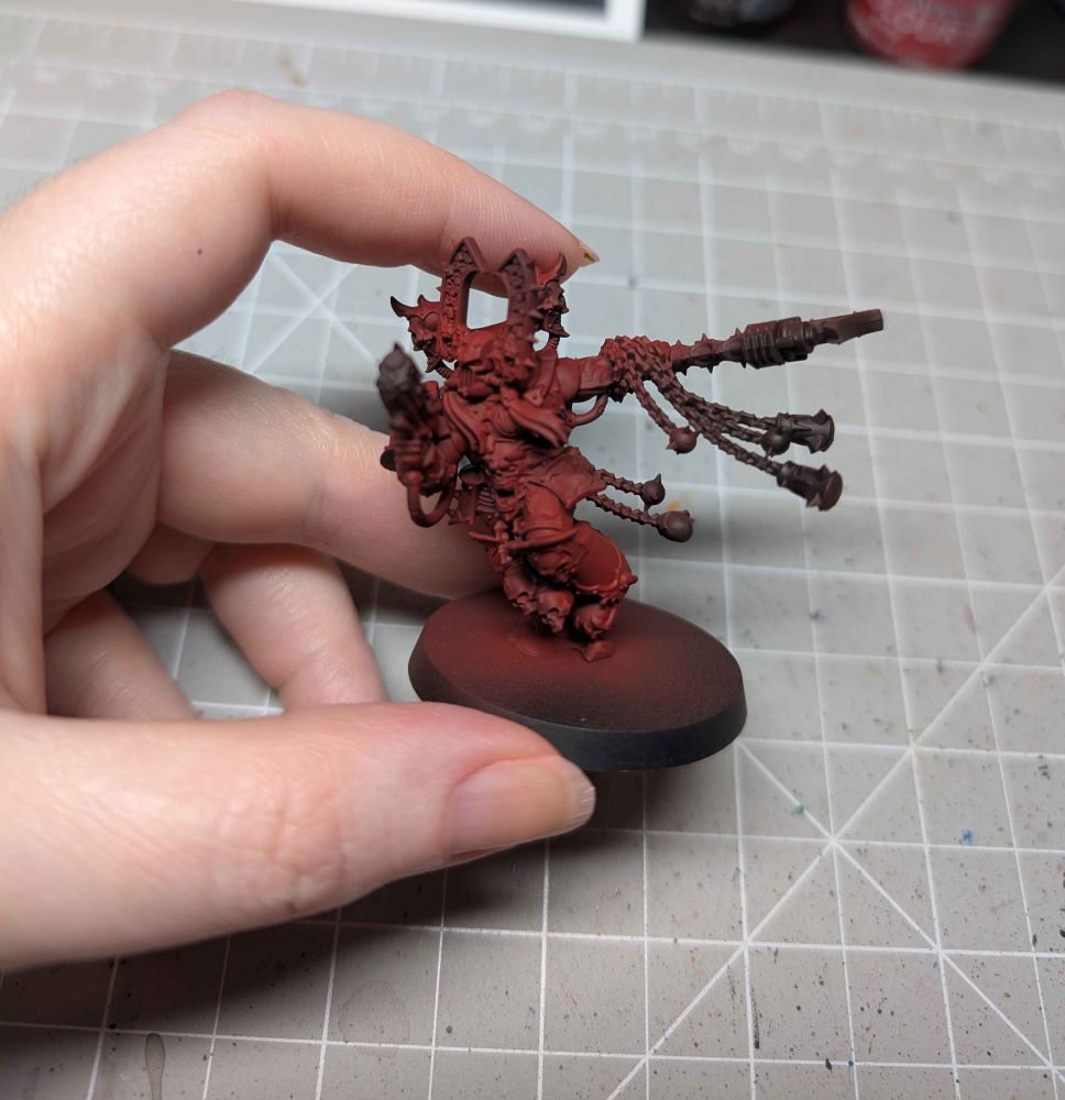 WIP of Kharn the Betrayer for Warhammer 40k - miniature is airbrushed in reds, no details started